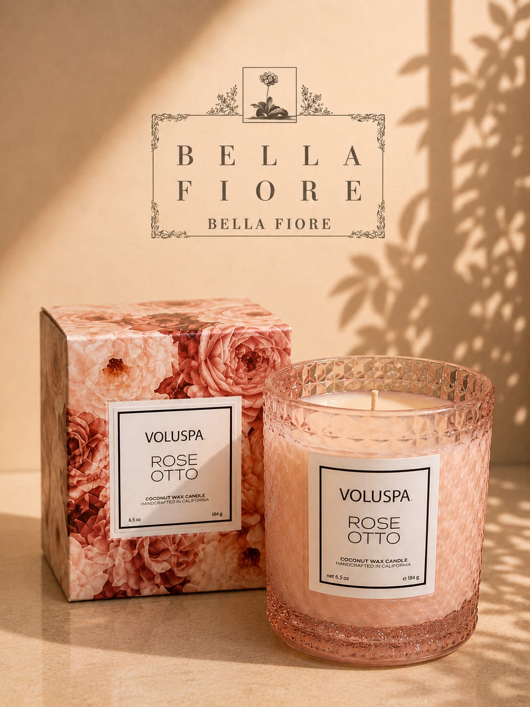 Pink rose-scented candle in a textured glass jar with matching box