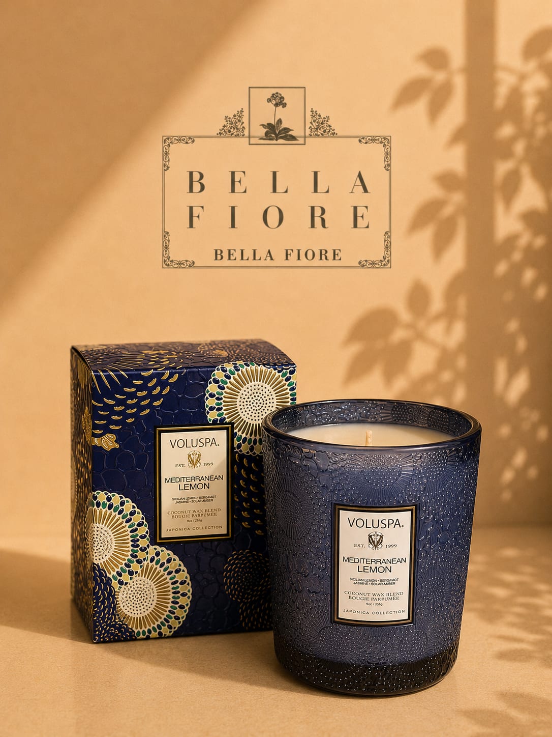Blue patterned candle in a box beside a matching candle jar