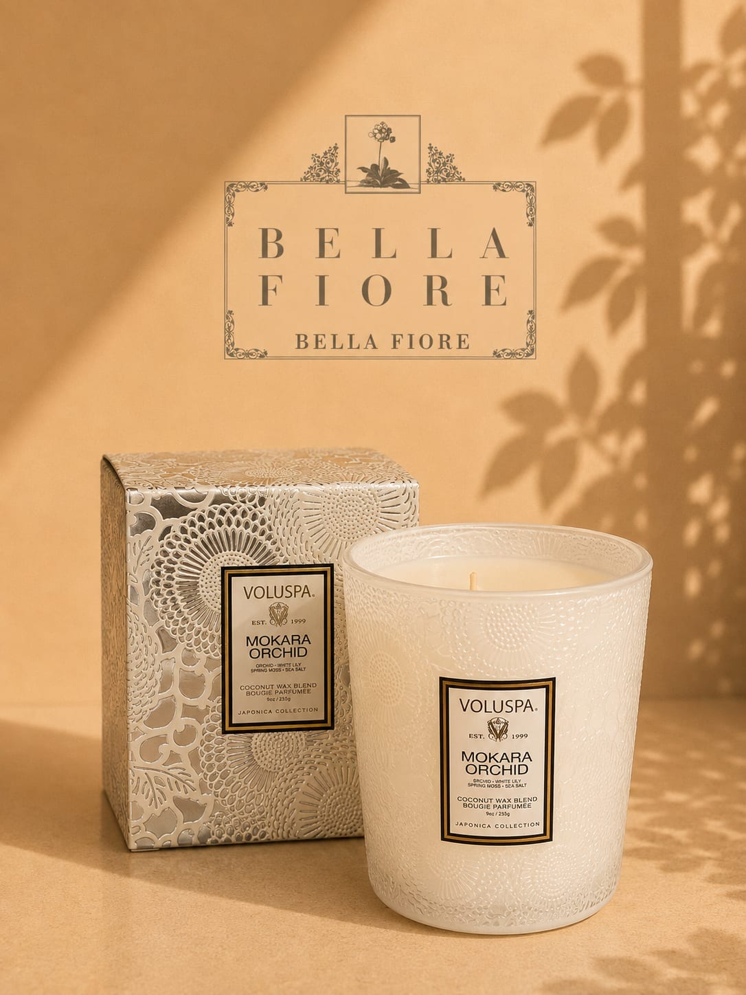 Decorative scented candle in a patterned glass jar with matching box
