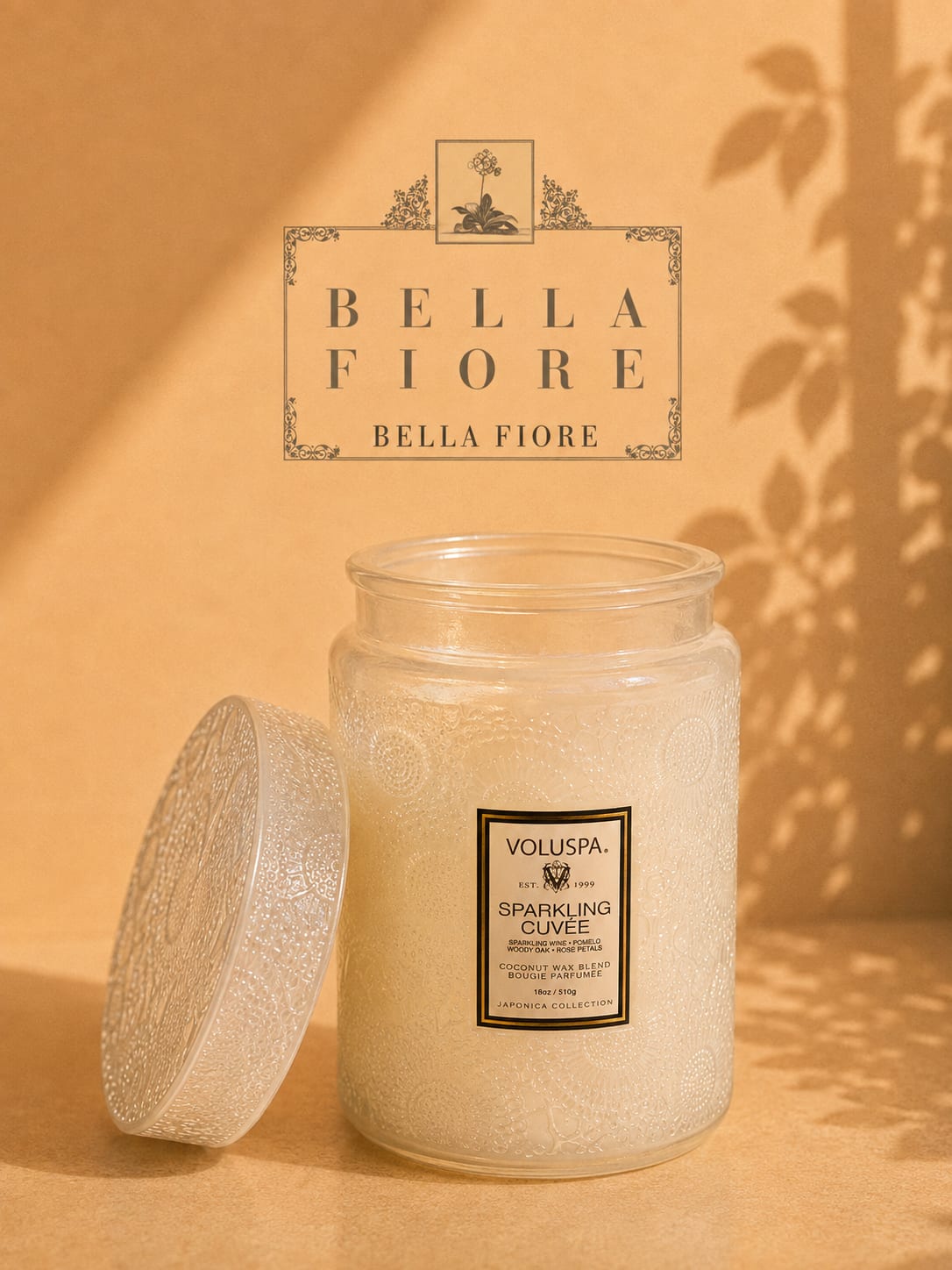 Glass jar candle with a decorative lid on a warm beige background
