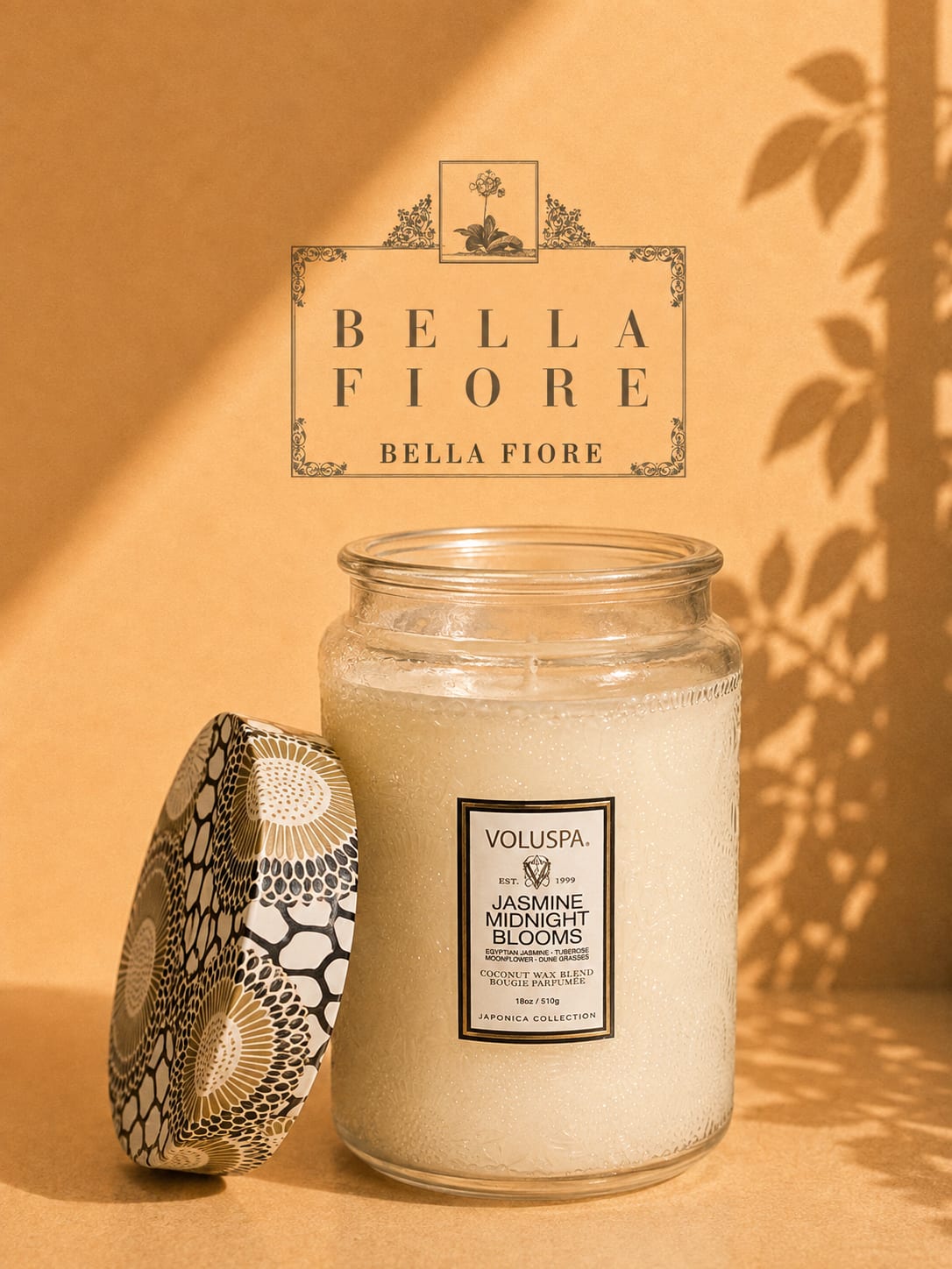 Glass jar candle with a patterned lid on a warm beige background