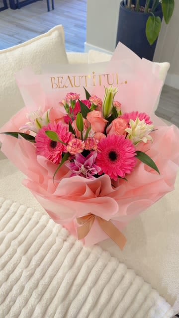 Pink mixed flower bouquet wrapped in pale pink paper