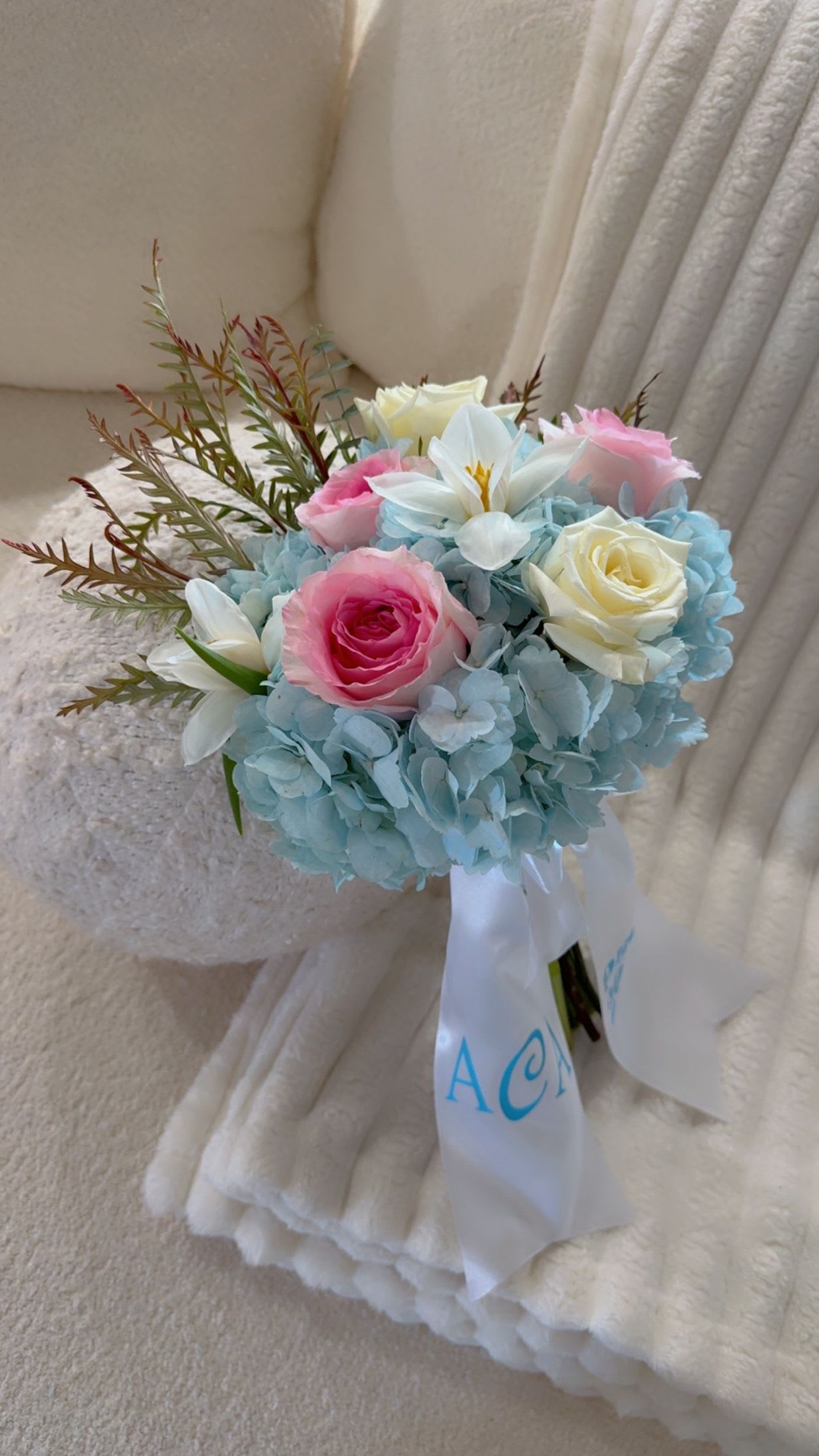 Blue Elegance Prom Bouquet” - A soft and romantic bouquet featuring sky-blue hydrangeas with blush and ivory roses. Finished with a custom personalized ribbon for a unique Prom 2026 touch.