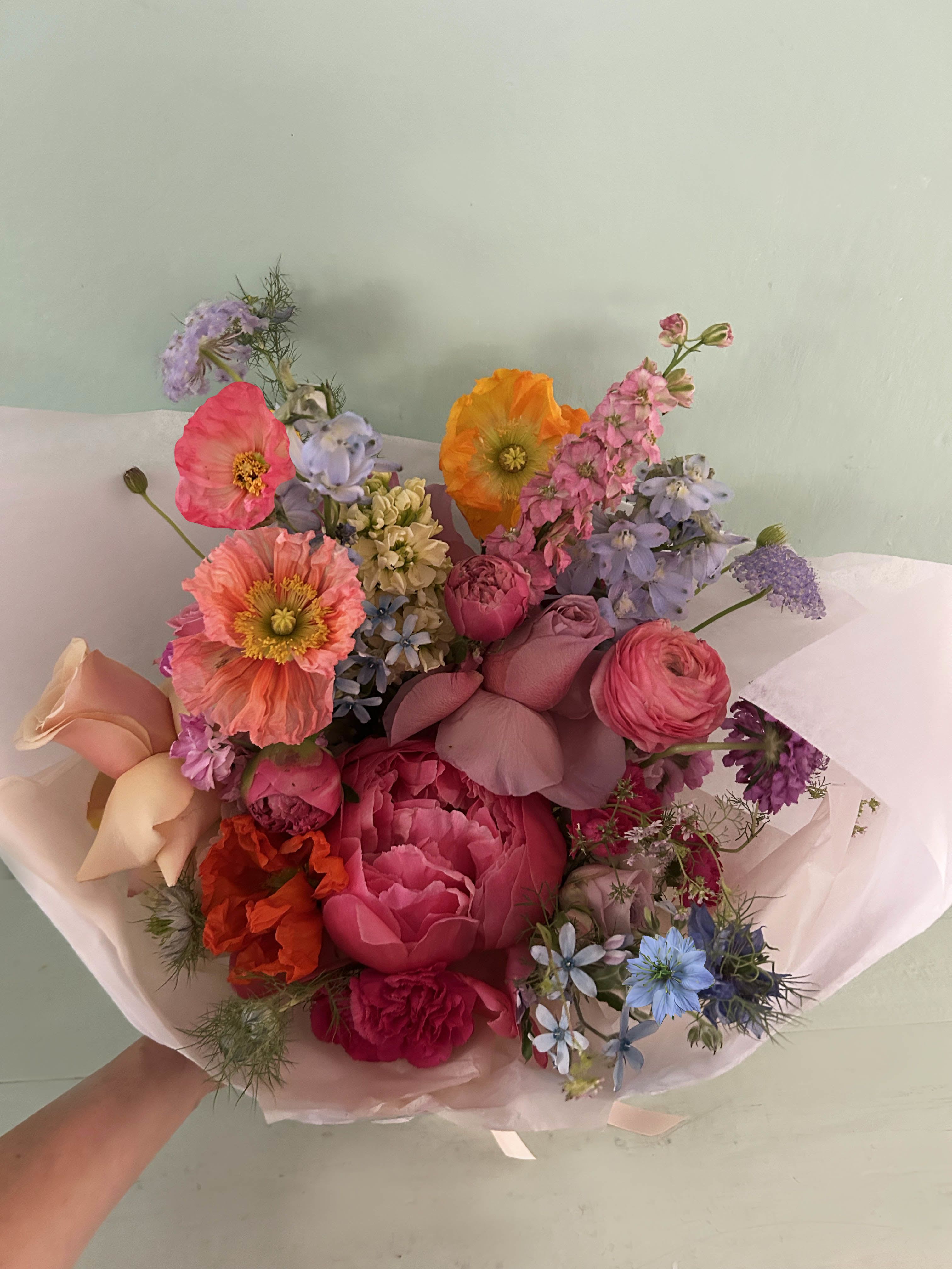 The Rhodes bouquet - The most happy and joyful hand tied bouquet absolutely perfect for Mother's Day. Just a bundle of pretty joy made of the most wonderful nand natural fresh stems of flowers, that please the eye, the nose and the heart. A gorgeous bouquet bound to impress. Peonies, roses, delphinium and other gorgeous stems of the season. Ready for hand delivery in LA by our own staff to ensure perfect and stress free delivery.