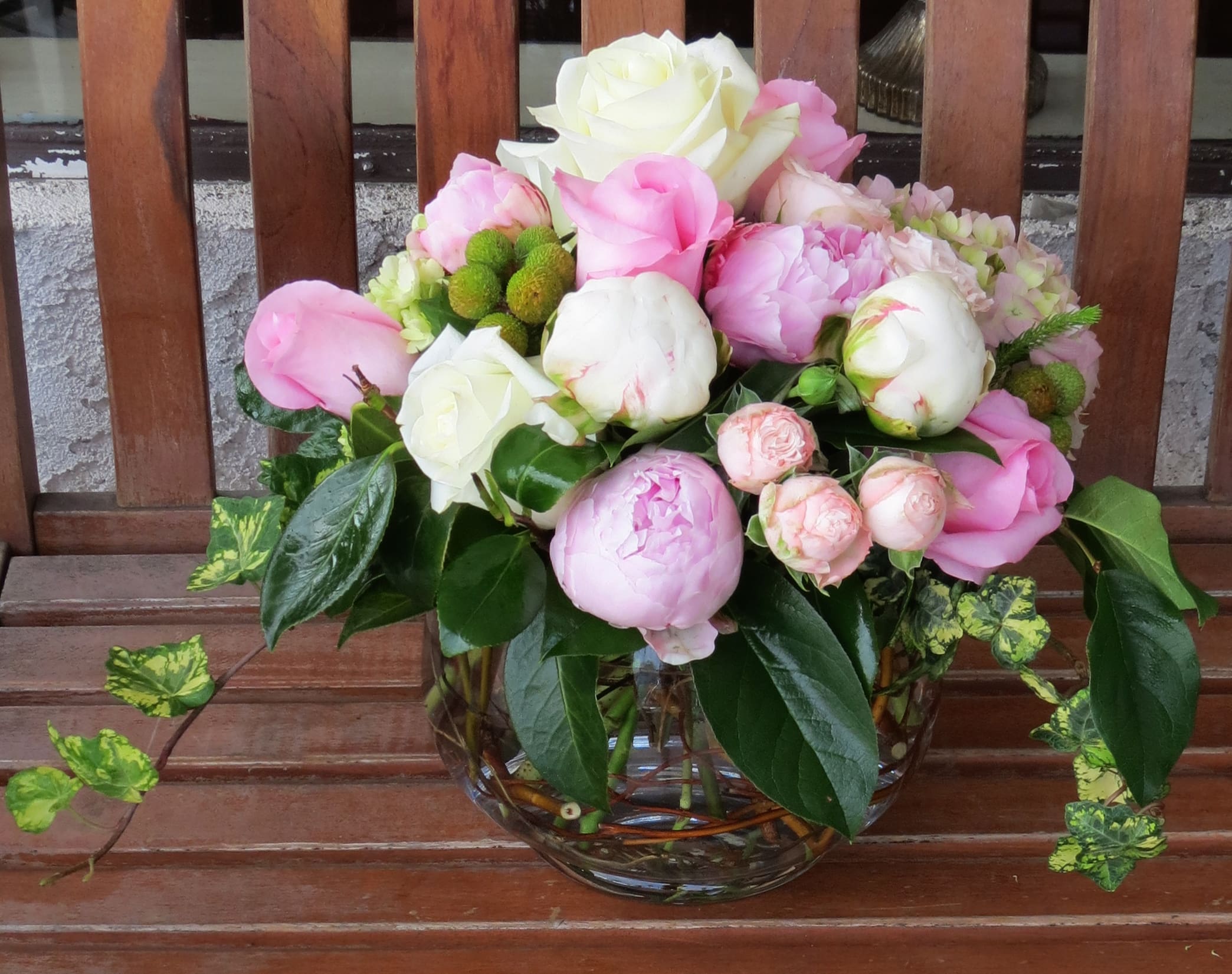 Pink and white flower arrangement in a glass vase
