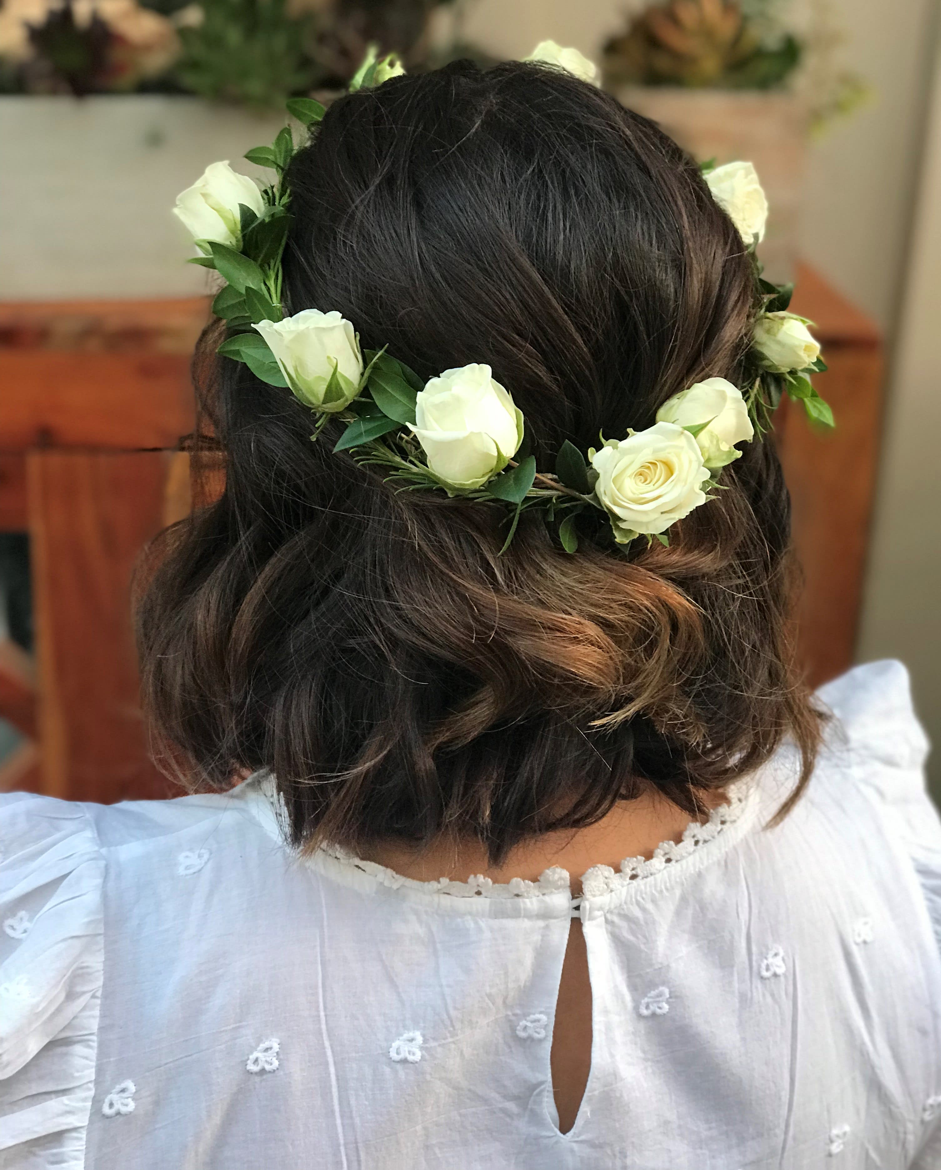 White rose flower crown on a woman's dark hair