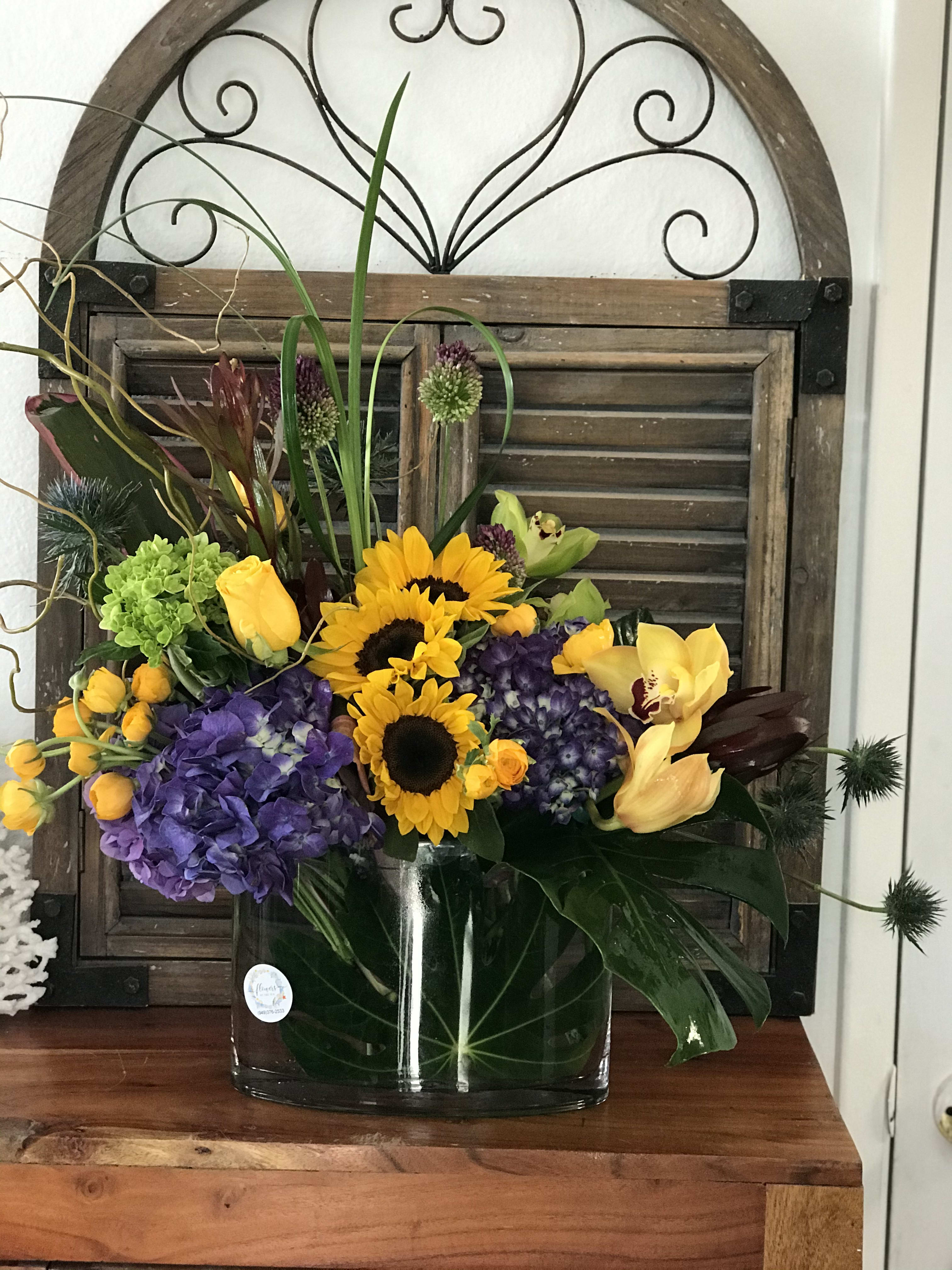 Colorful mixed flower arrangement in a clear glass vase