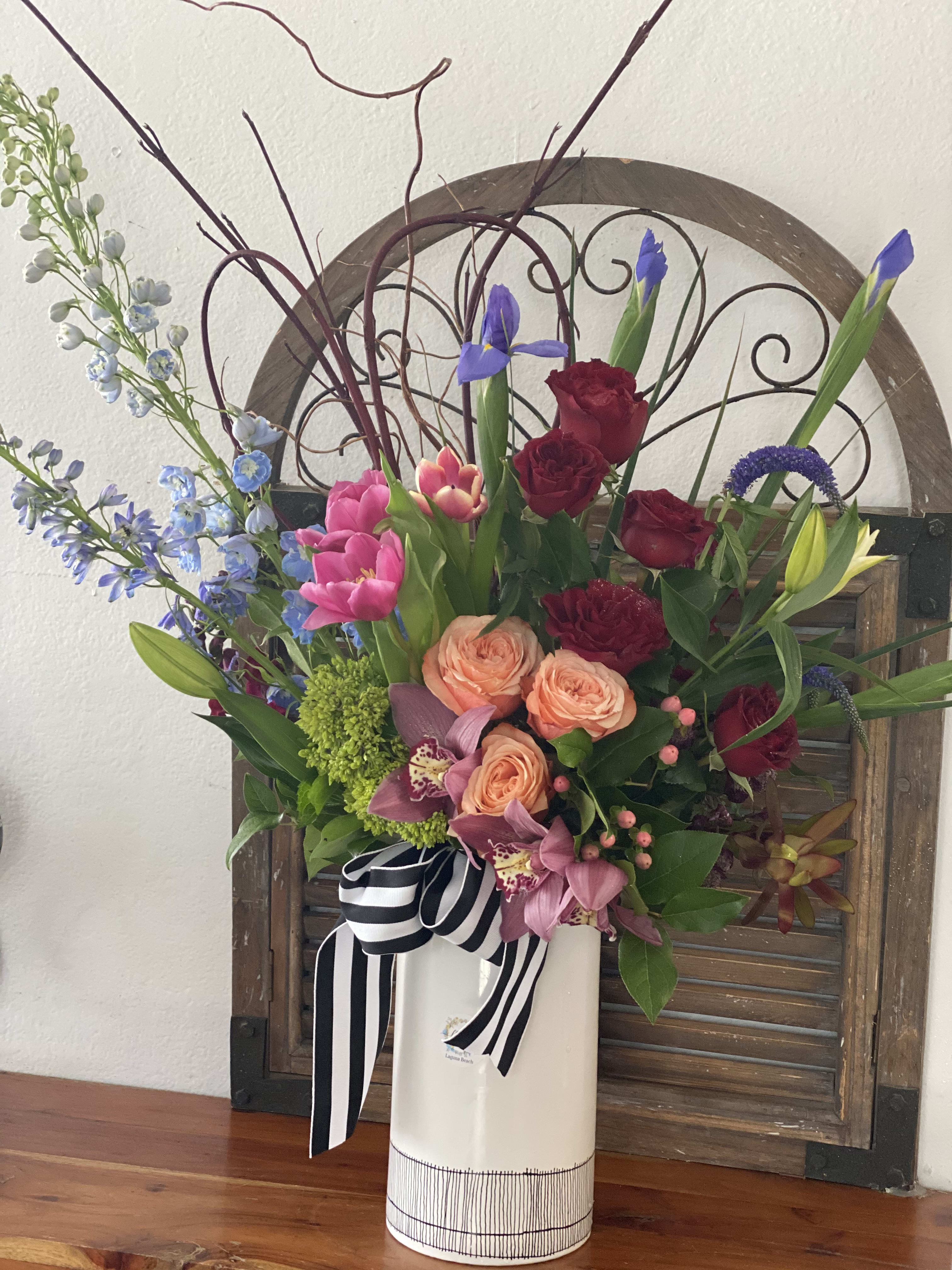 American Love  - Tall Extraordinary  rainbow arrangement, in ceramic white vase and  color flowers.   