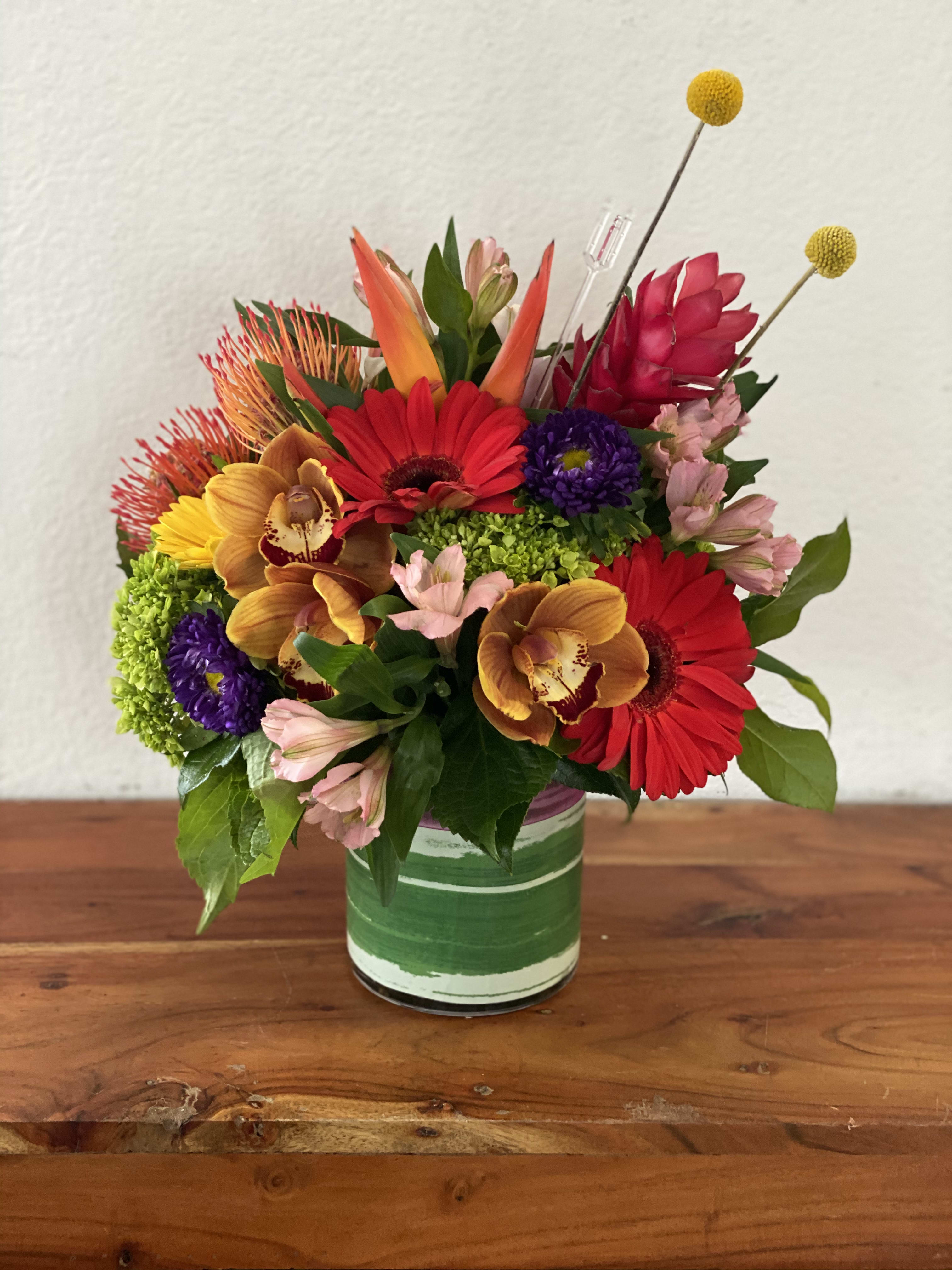 Colorful mixed bouquet in a green-striped glass vase
