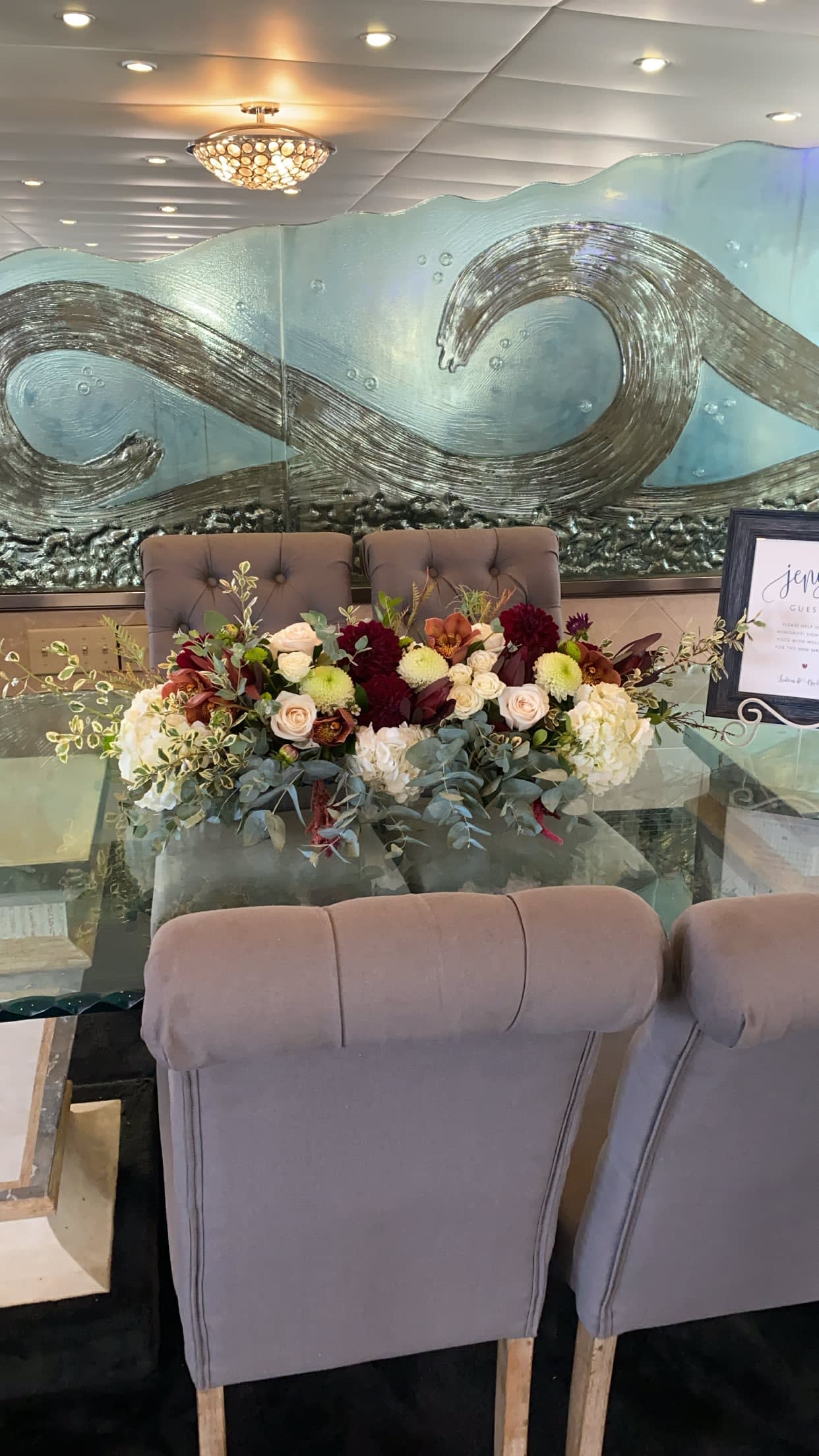 Low floral centerpiece with roses and mums on a table