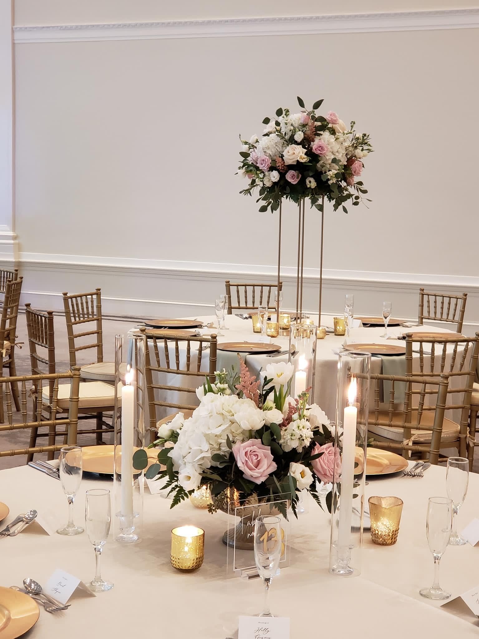 Floral centerpieces with pink and white roses on a banquet table