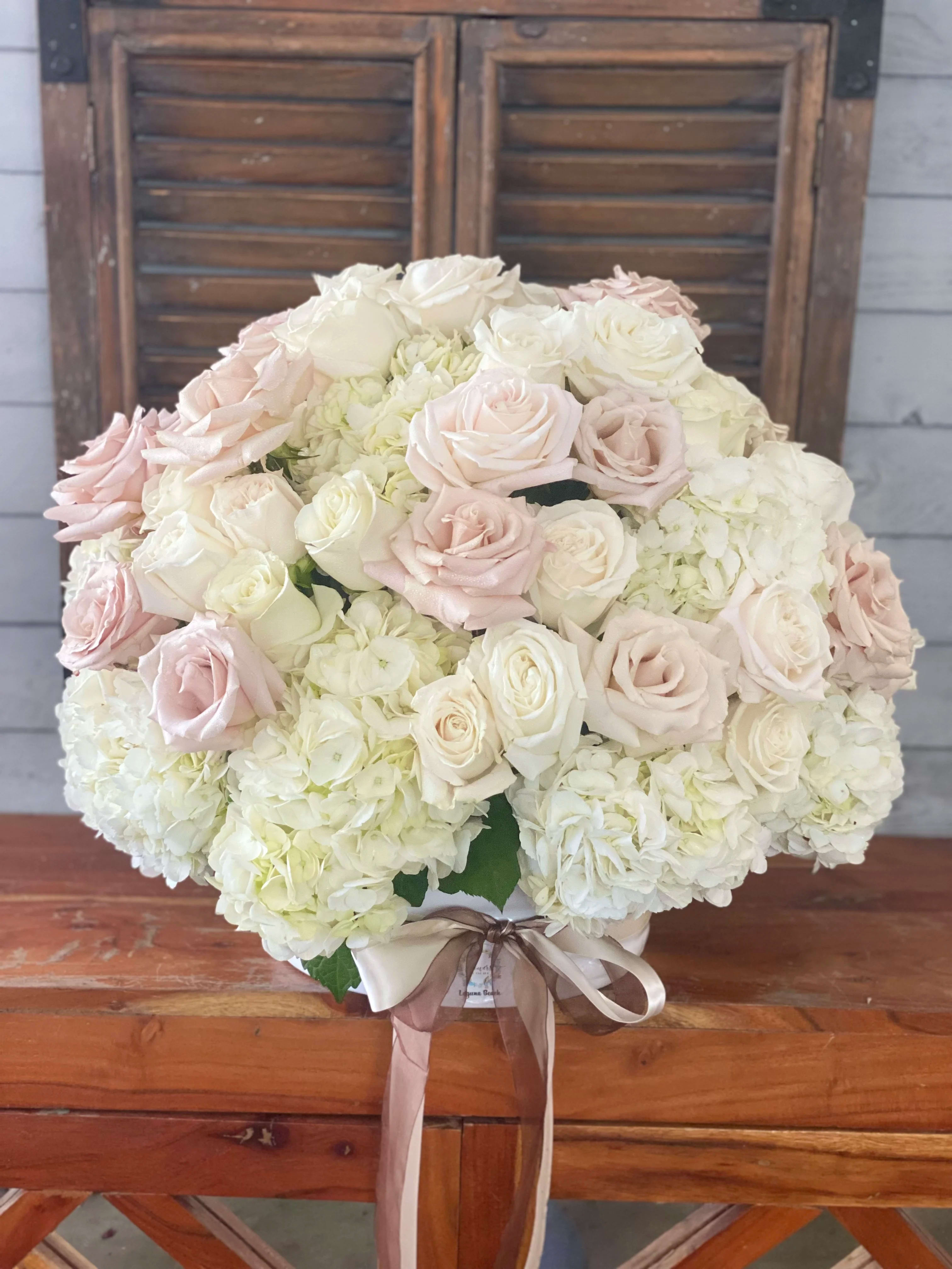 Large bouquet of pale pink and white roses with white hydrangeas