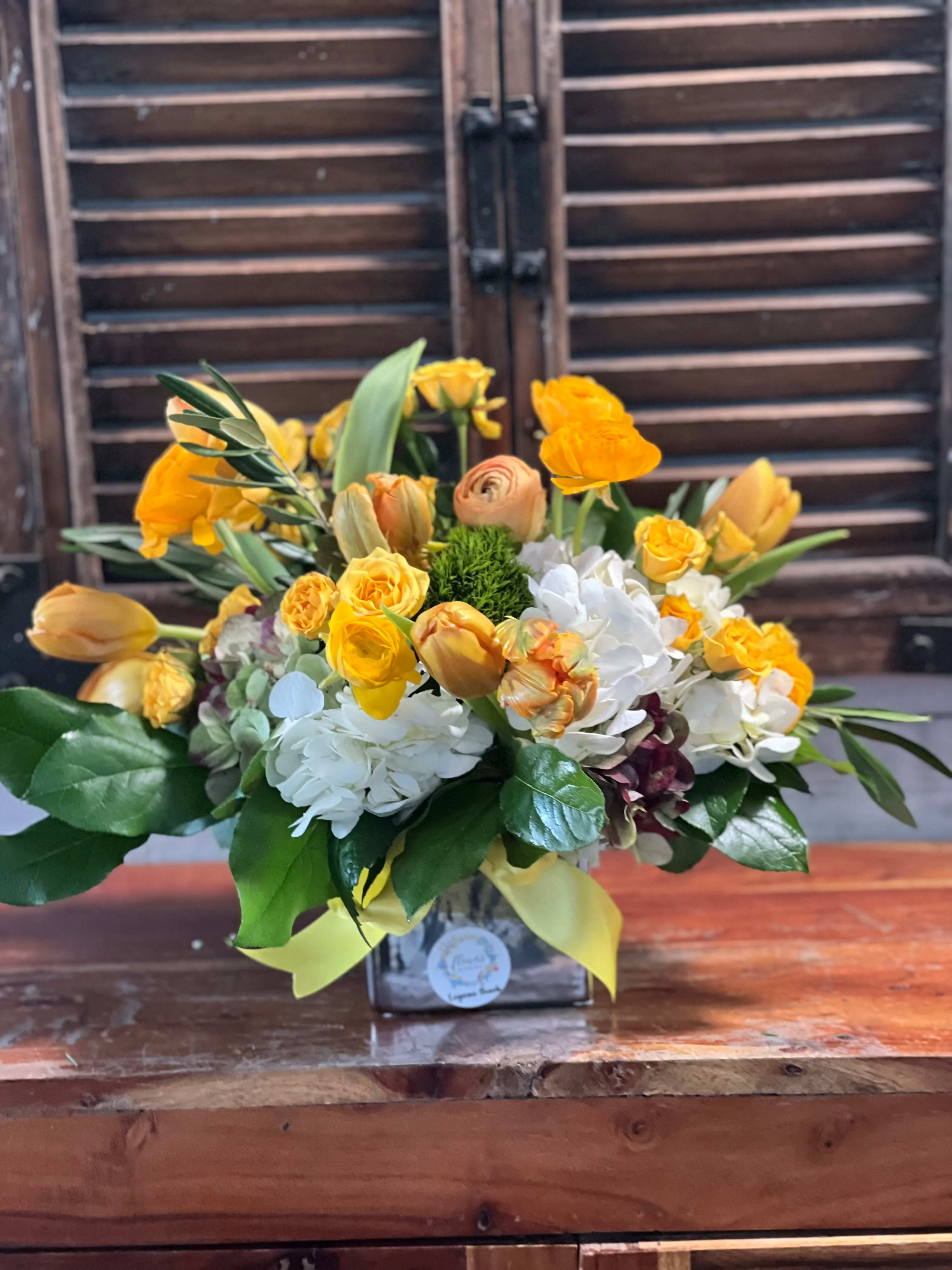 Yellow and white mixed bouquet in a square vase with ribbon