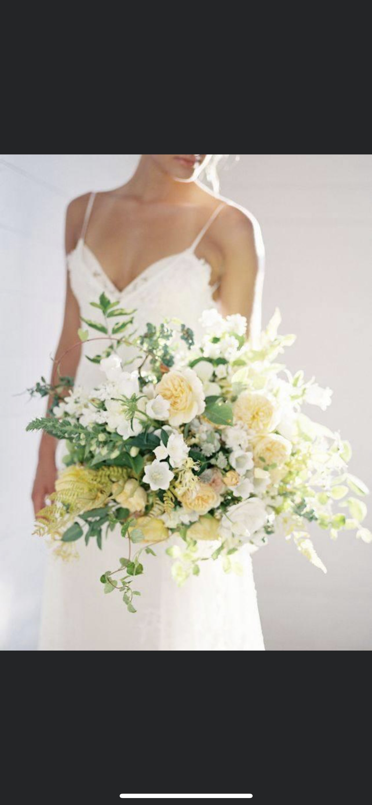 Bride holding a large white and pale yellow bouquet