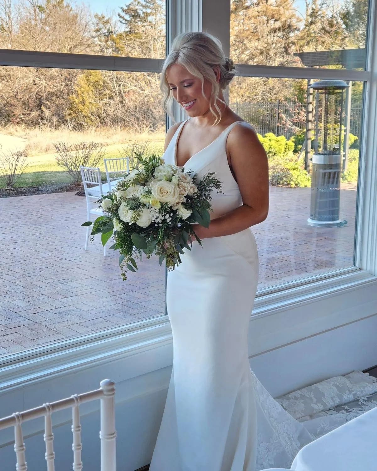 Bride holding a white and green bouquet