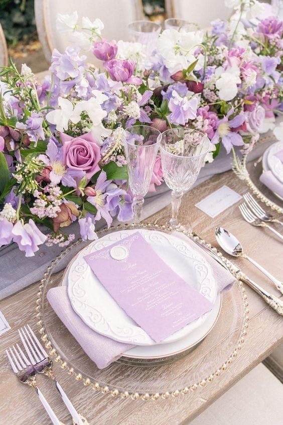 Lavender and white floral table centerpiece with place settings