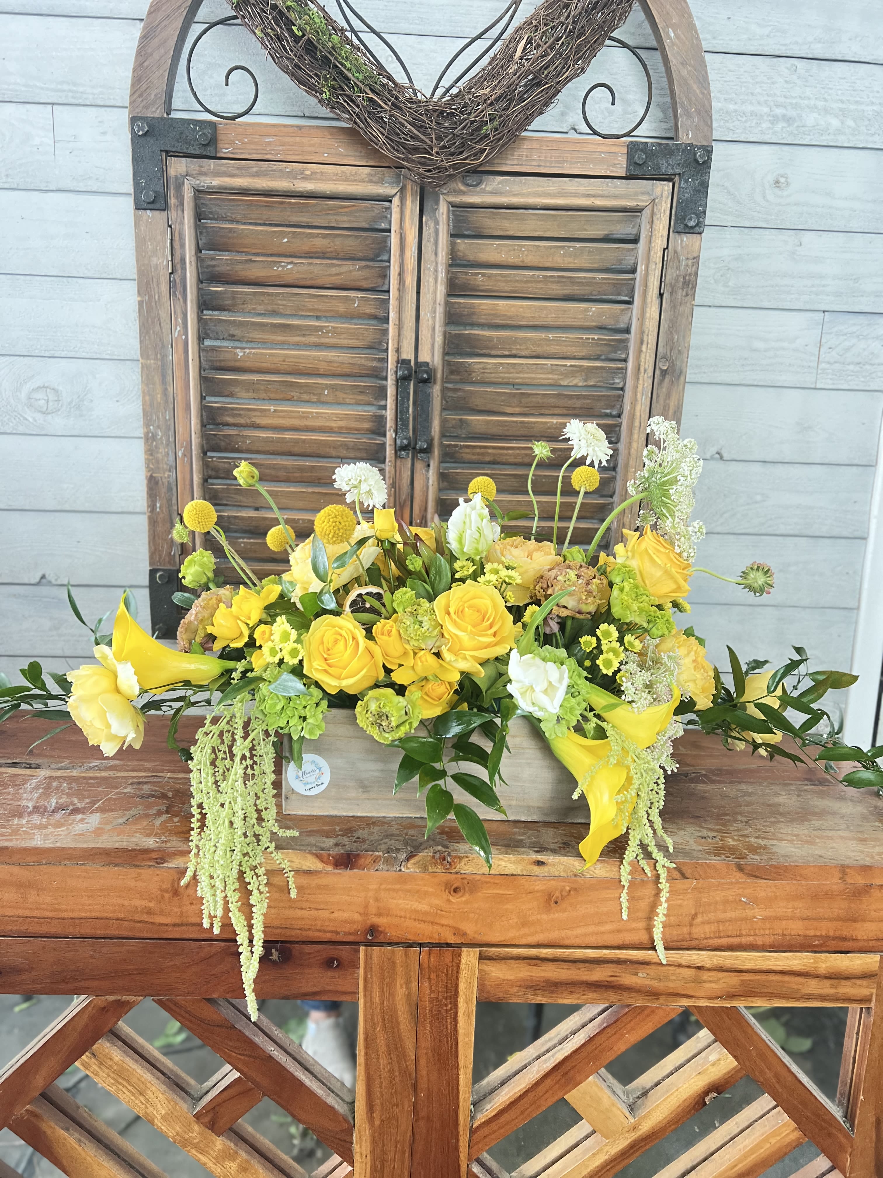 Napoli  - Yellow Premium flowers in wood basket .