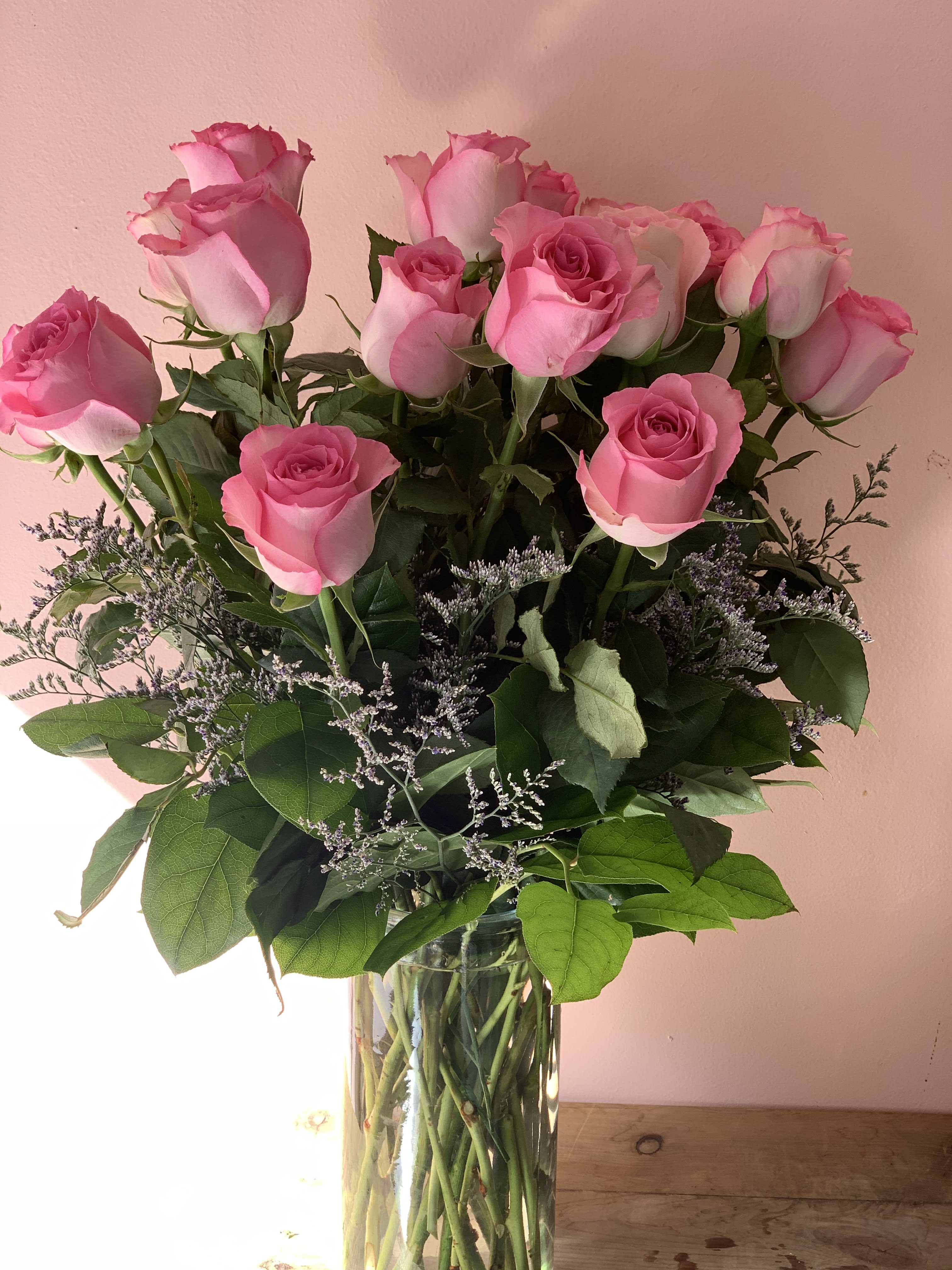 Pink roses arranged in a clear glass vase