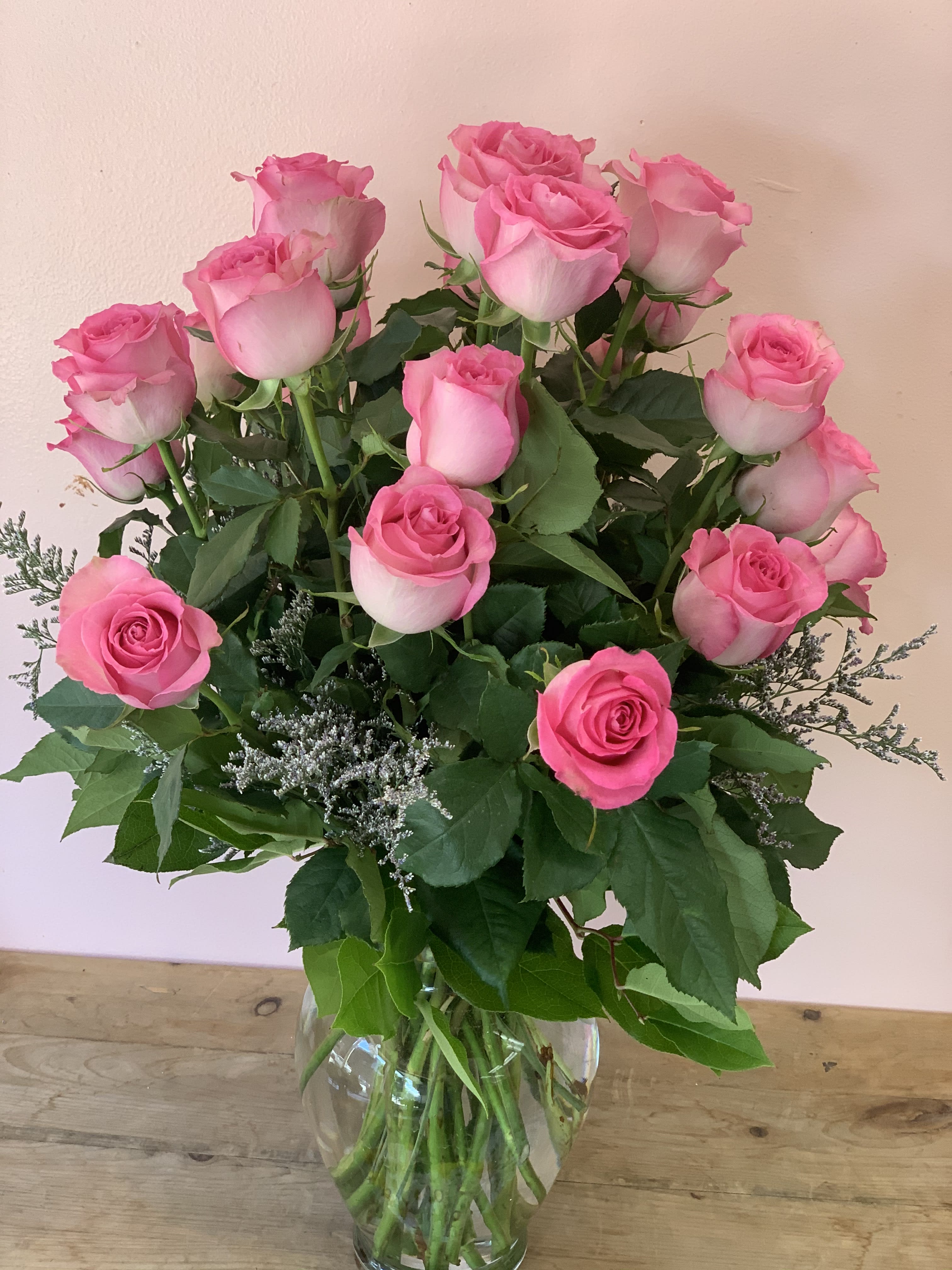 Bouquet of pink roses in a clear glass vase