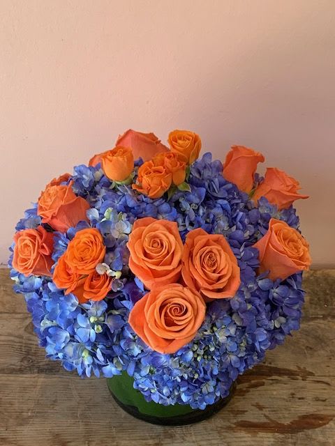 Banded Karner | Butterfly-Inspired Flower Delivery in San Francisco - Capture the supernatural elegance of nature with the Banded Karner, a striking floral tribute inspired by the vibrant contrast of butterfly wings. As a dedicated San Francisco florist, Fillmore Florist has engineered this arrangement for those who seek an aesthetic that is both bold and sophisticated. It is the definitive choice for San Francisco flower delivery when you want to send a gift that feels like a living work of art. Made with orange Roses, Mimicking the warm, sun-drenched hues of rare butterfly species. Blue Hydrangeas, that makes the orange blooms pop. Modern Leaf-Wrap vase, a professional finishing touch that conceals the stems and elevates the design. Fillmore Florist Trust Guarantee     Year-Round Availability: We maintain a consistent supply of these specific blooms to ensure the Banded Karner is available for flower delivery in San Francisco 365 days a year. This reliability is your proof of our status as a permanent, local San Francisco florist—not a seasonal pop-up.      Professional Delivery: Our team of local professionals manages every step of the logistics. We deliver your striking flowers straight to the recipient's front door, ensuring the delicate blue-and-orange balance remains intact during transit.      Hand-Crafted Integrity: Every Banded Karner is made-to-order in our local shop. This hand-crafted approach is quality ensured, distinguishing your gift from mass-produced, warehouse-stored floral products.  Approximate Dimensions: 12” H x 12” W 