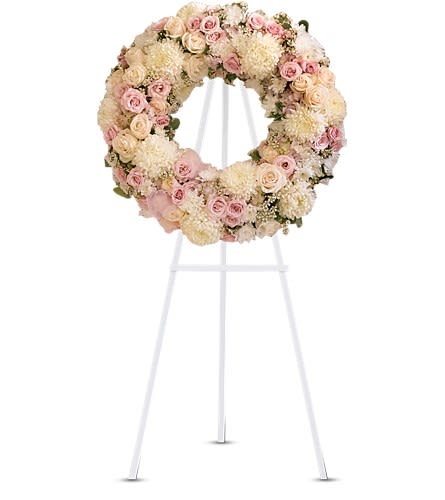 Peace Eternal Wreath - T236-1A - A breathtaking expression of love and devotion this lovely wreath delivers a message that is both subtle and strong. Its soft pastel blossoms will soothe while its extraordinary beauty will express the depth of your emotions. Gorgeous pink hydrangea cr?me roses light pink spray roses white chrysanthemums waxflower and more are adorned by pink organza ribbon in this eternal circle of peace.Approximately 24 1/2" W x 24 1/2" H Orientation: One-Sided As Shown : T236-1A