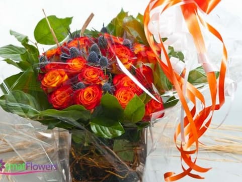 Bouquet of orange-red roses with green leaves and orange ribbon