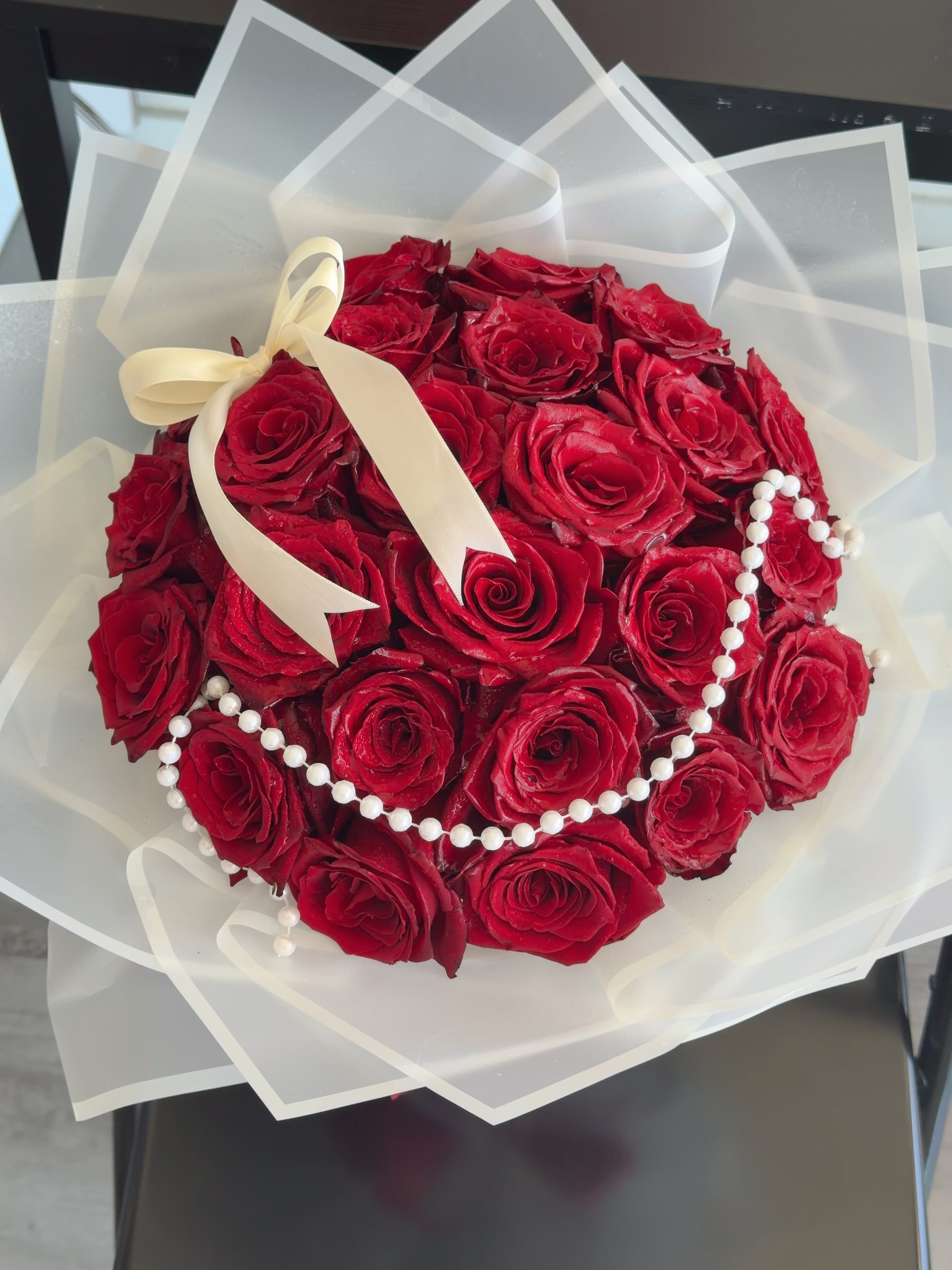 Pearl Embrace (Rose bouquet) - Pearl Embrace  Pearl Embrace features premium roses accented with an elegant pearl garland and wrapped in signature Korean-style paper. Timeless and romantic, it’s the perfect choice for anniversaries, birthdays, proposals, Valentine’s Day, or any special occasion.  Available in Standard, Deluxe, and Premium sizes. The standard rose color is red, but rose color, wrapping paper, and ribbon can all be customized upon request. Simply leave your preferences in the order notes at checkout. Each bouquet is handcrafted with fresh flowers, and slight seasonal variations may occur while maintaining the same elegant design.