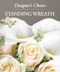 White calla lilies and cream roses in a standing wreath