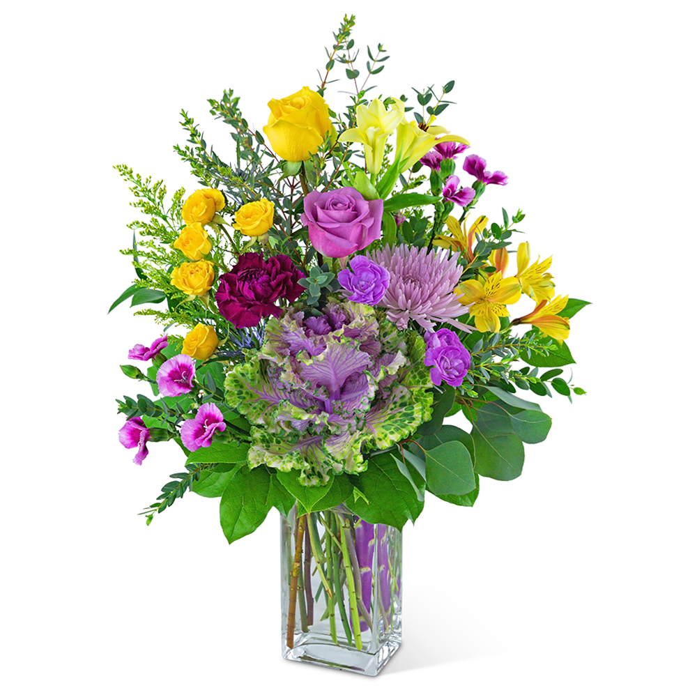 Mixed bouquet of yellow, purple, and pink flowers in a clear glass vase