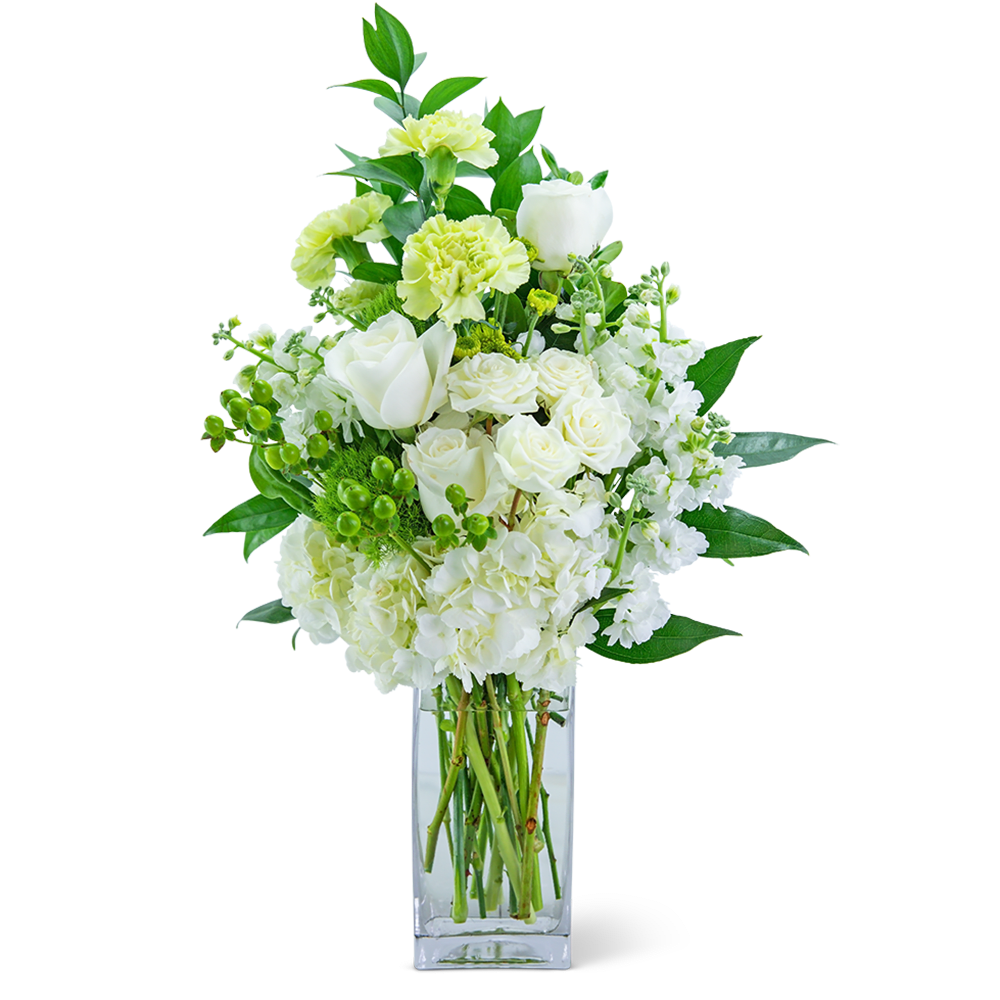 White and pale green floral arrangement in a clear glass vase