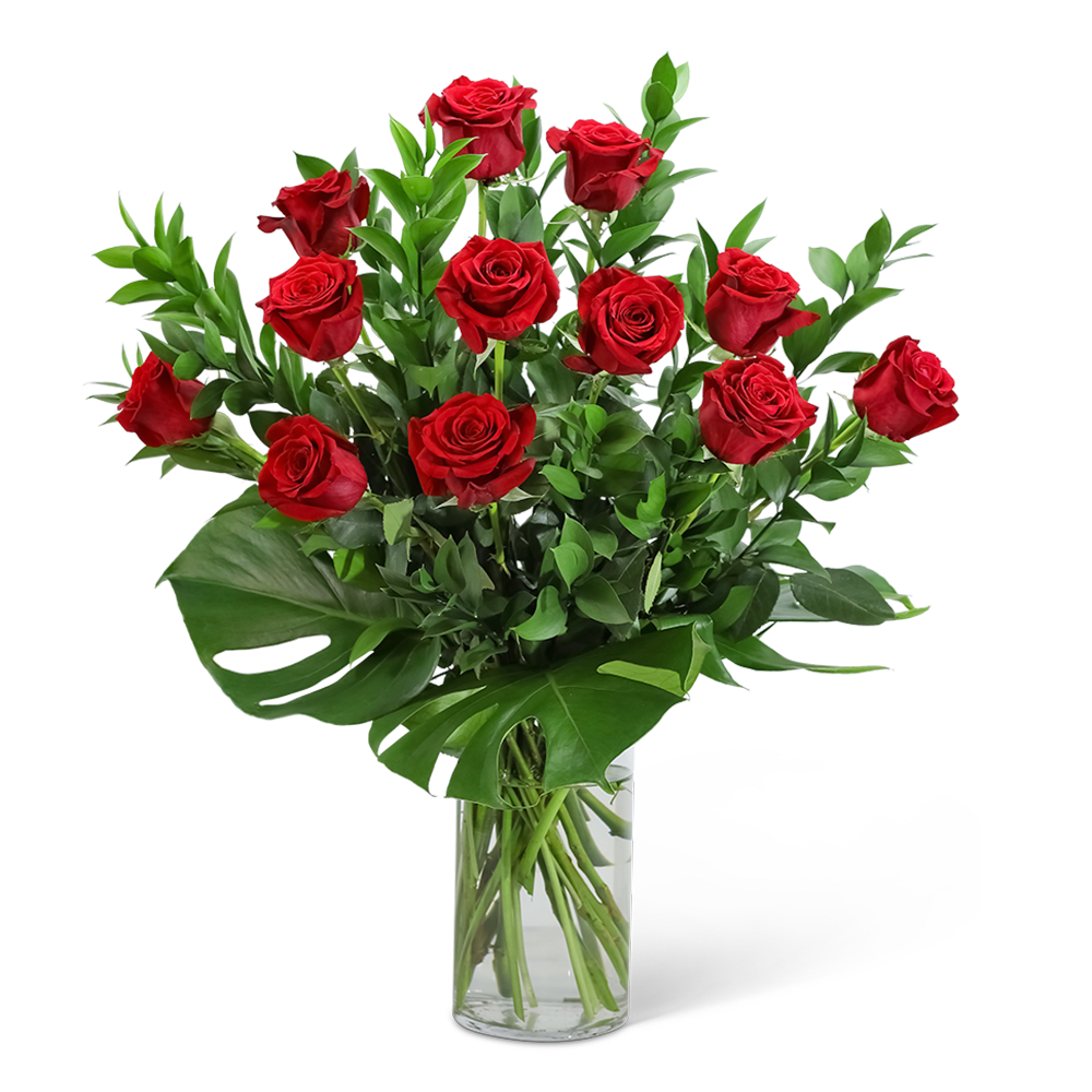 Red roses arranged in a clear glass vase