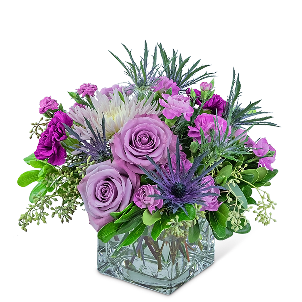 Lavender roses and purple flowers in a clear glass vase