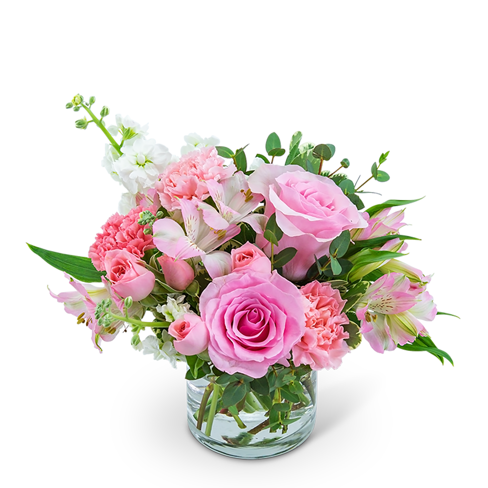 Pink roses and carnations in a clear glass vase