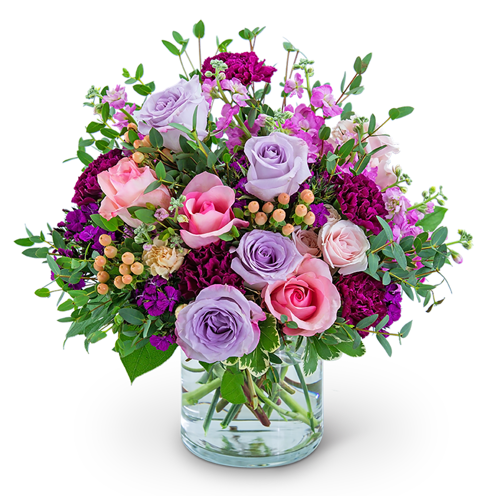 Bouquet of pink and lavender roses in a clear glass vase