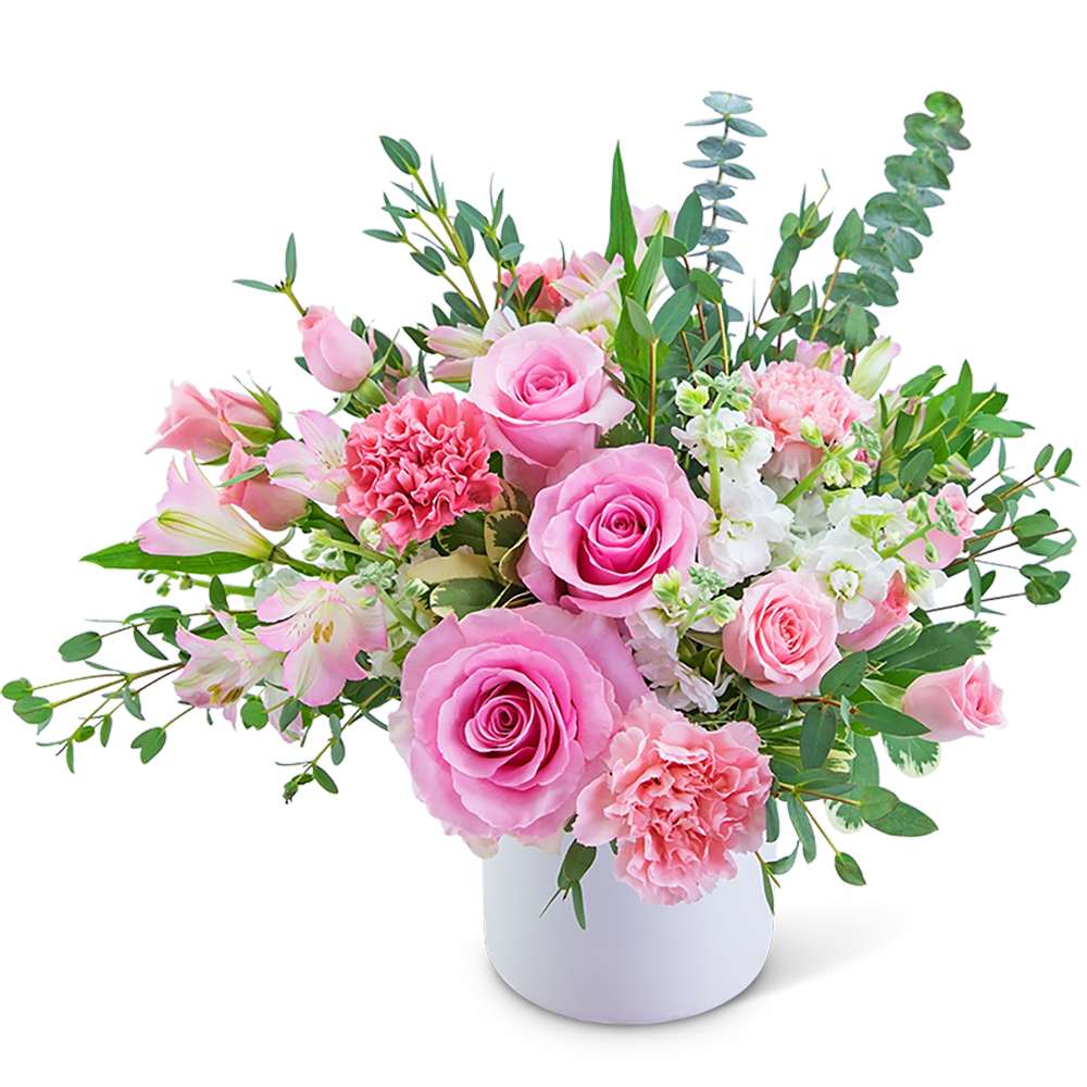 Pink roses and carnations in a white vase with mixed greenery