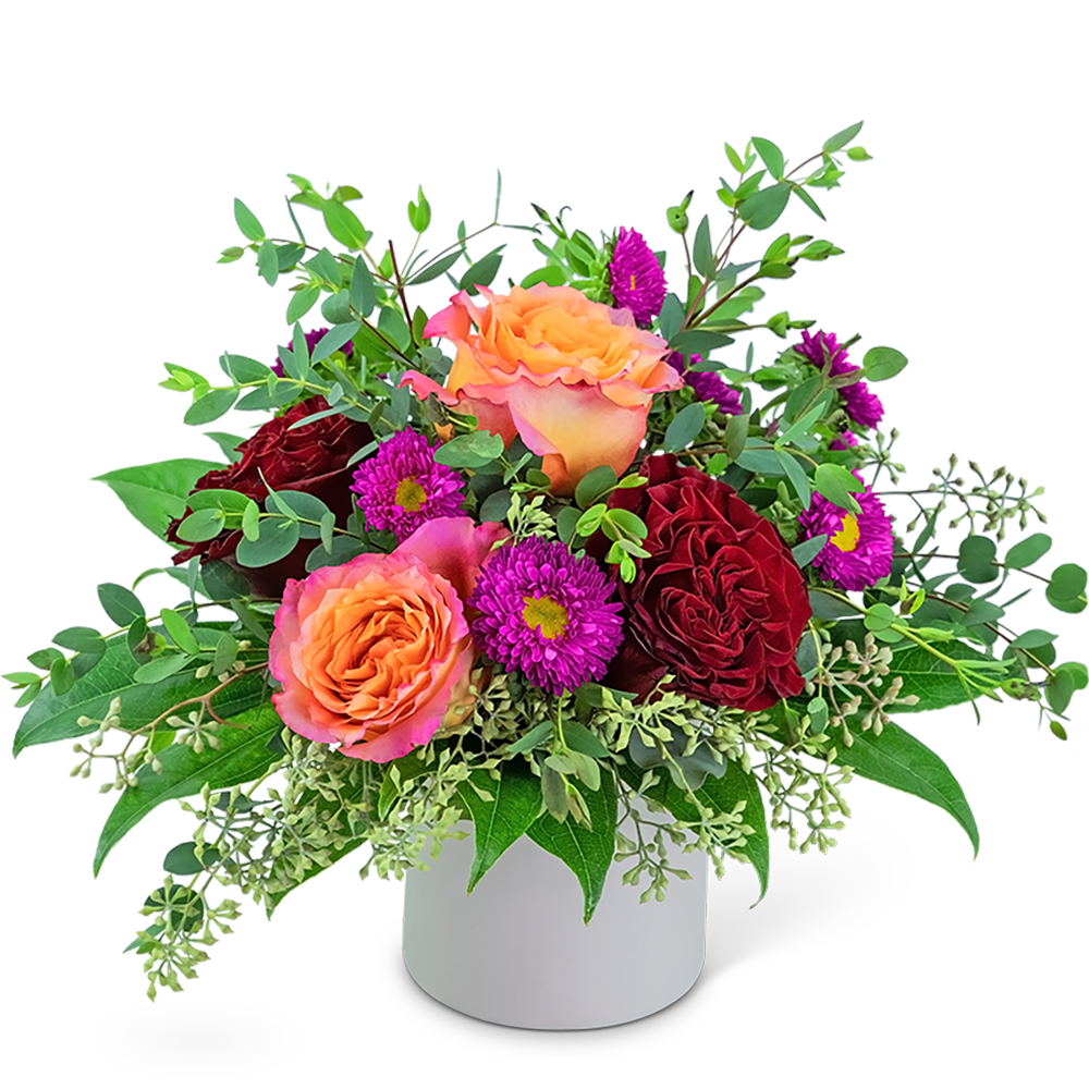 Bouquet of orange and red roses with purple daisies in a white vase