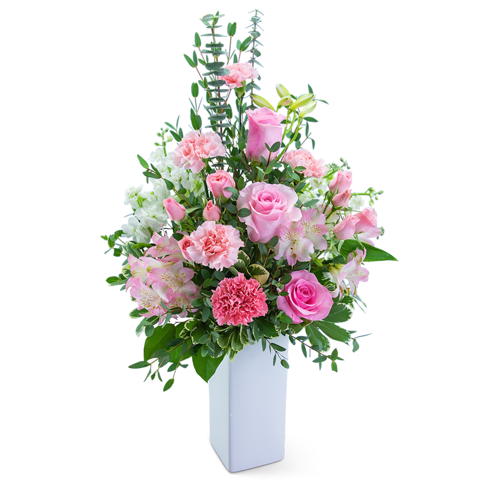 Pink and white floral arrangement in a tall white vase