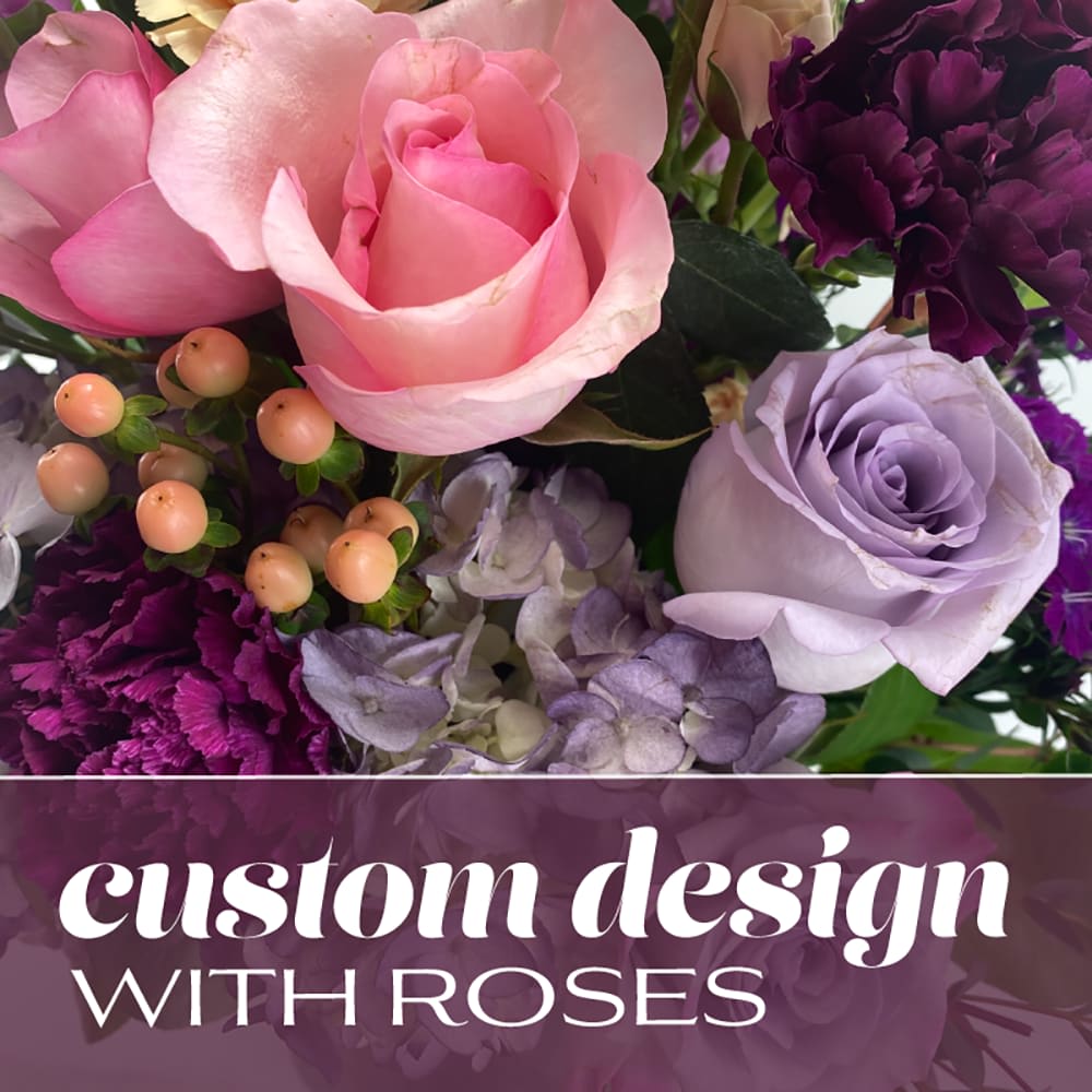 Pink and lavender roses with purple carnations and berries