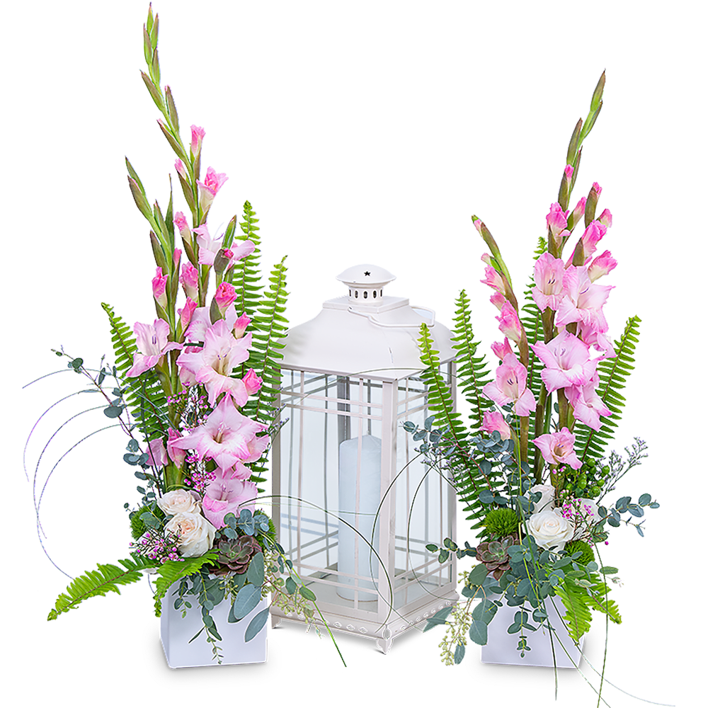 Pink gladiolus arrangements flanking a white lantern centerpiece