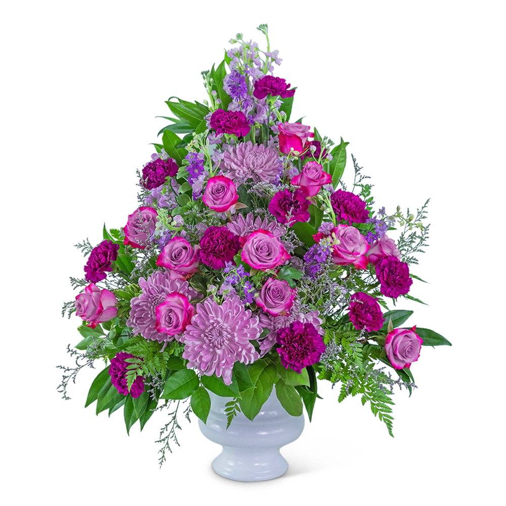 Pink and purple floral arrangement in a white vase