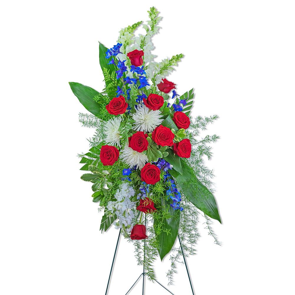 Tall standing floral spray with red roses, white blooms, and blue flowers