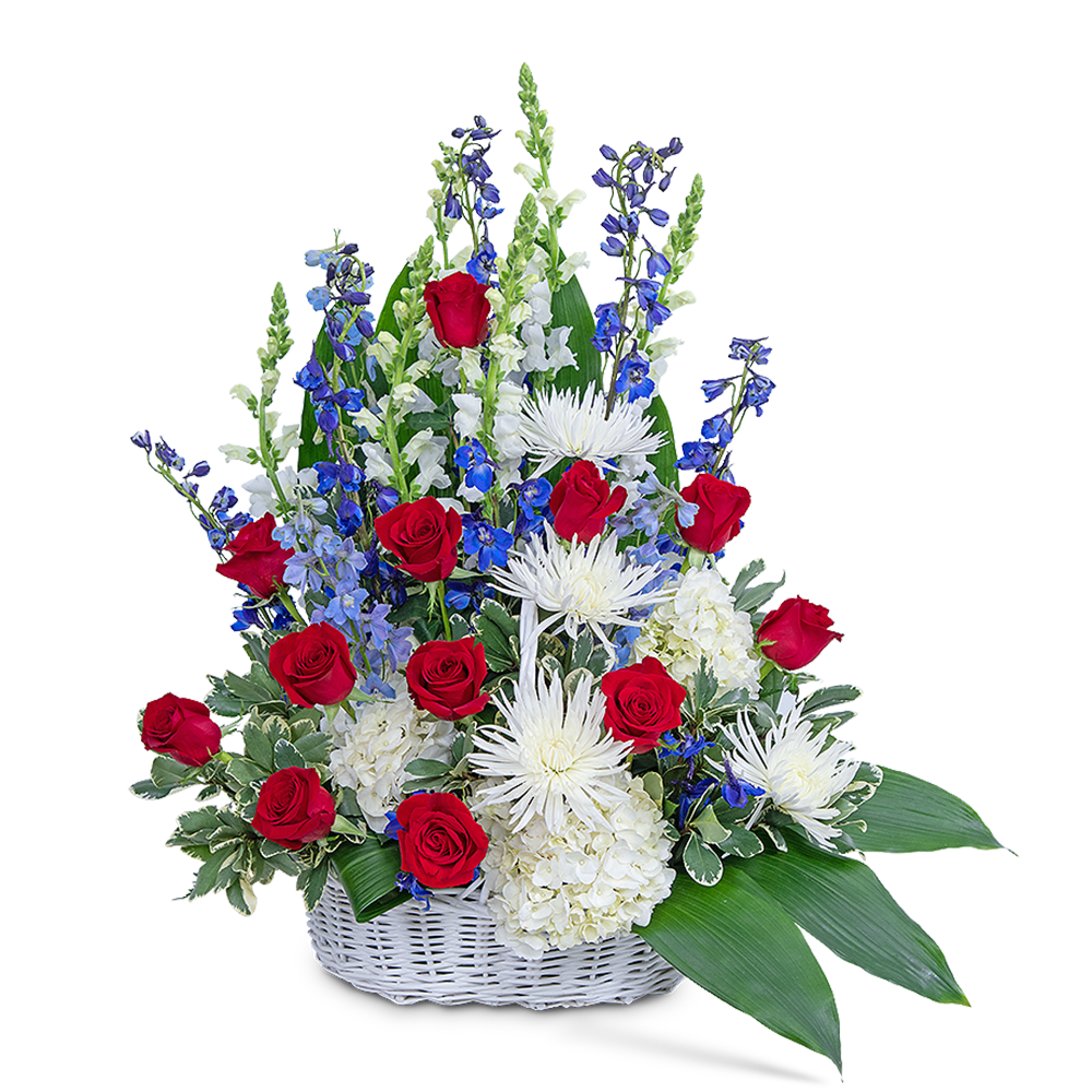 Basket arrangement of red roses, white blooms, and blue flowers