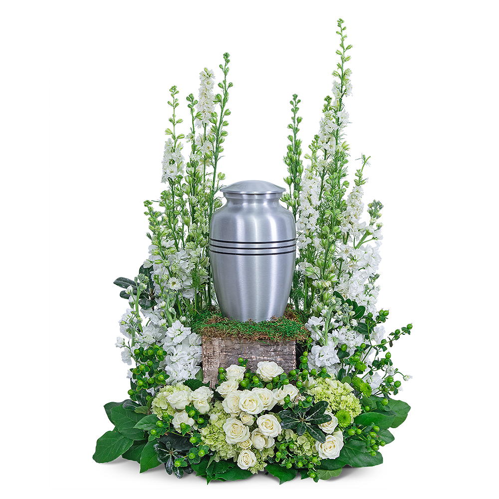 White floral funeral urn arrangement with a silver urn centerpiece