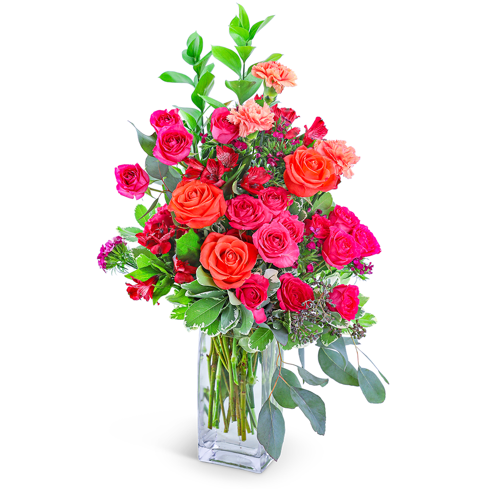 Pink and orange roses in a clear glass vase