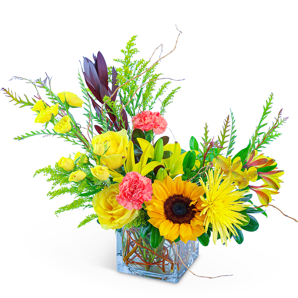 Bright mixed bouquet in a clear square vase with sunflowers and yellow roses