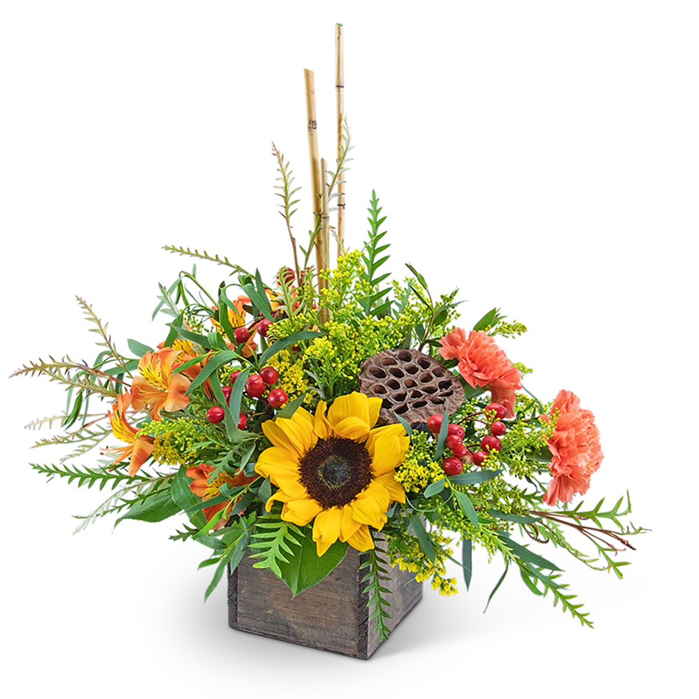 Sunflower arrangement in a wooden box with orange blooms and berries