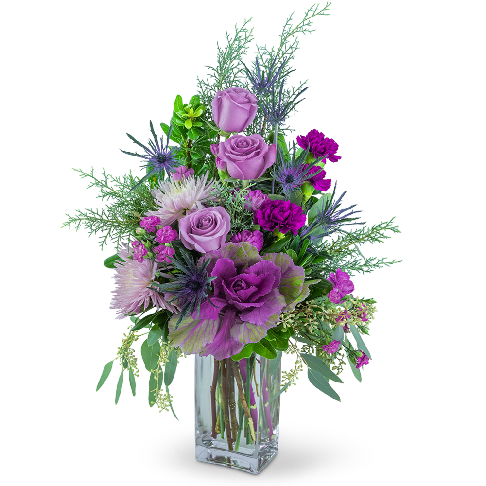Purple and pink floral arrangement in a clear glass vase