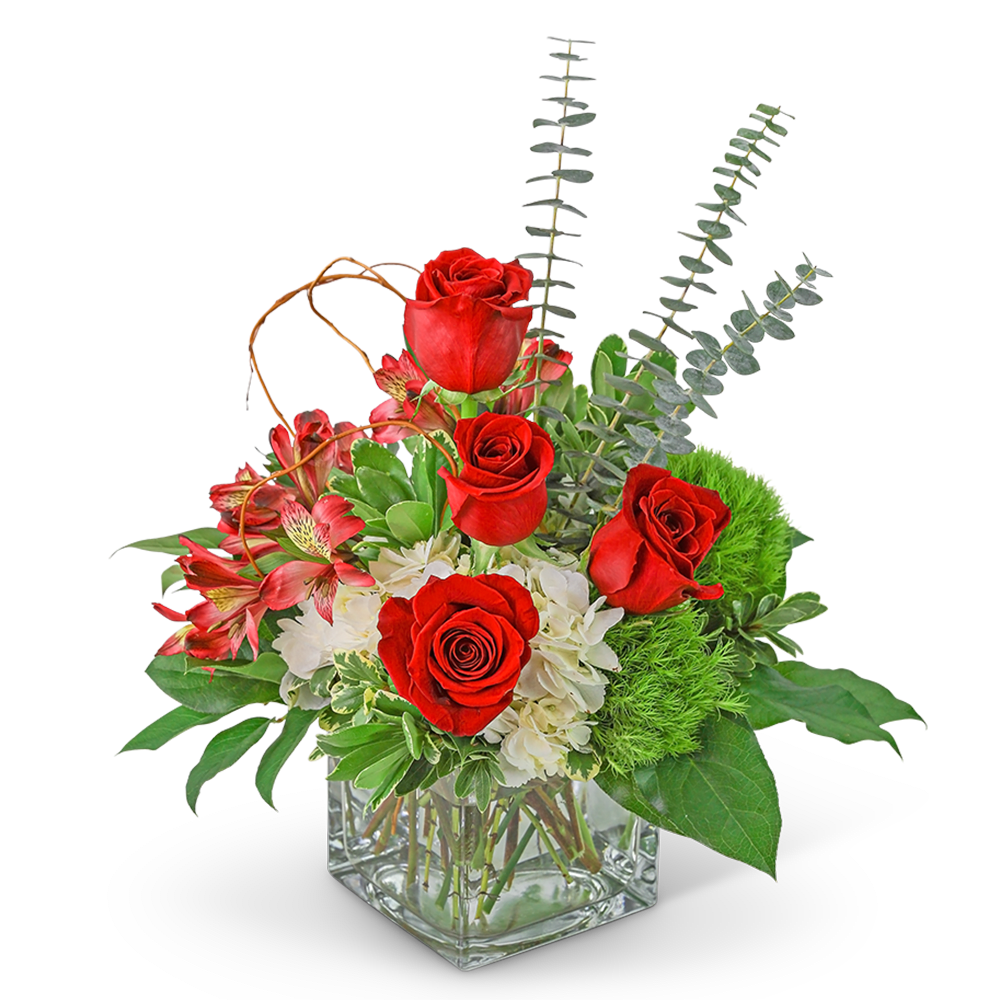 Red roses and pink flowers in a clear square vase