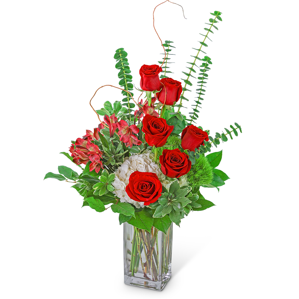 Red roses and pink flowers in a clear glass vase