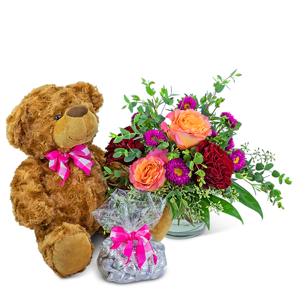Flamenco Gift Ensemble - Flamenco Gift Ensemble is the perfect gift for your loved one. The bright floral bouquet features premium roses and Matsumoto Asters accented with a variety of foliage. It comes with a fluffy plush bear and a chocolate bag of Hugs and Kisses.  *Items may vary based on availability.